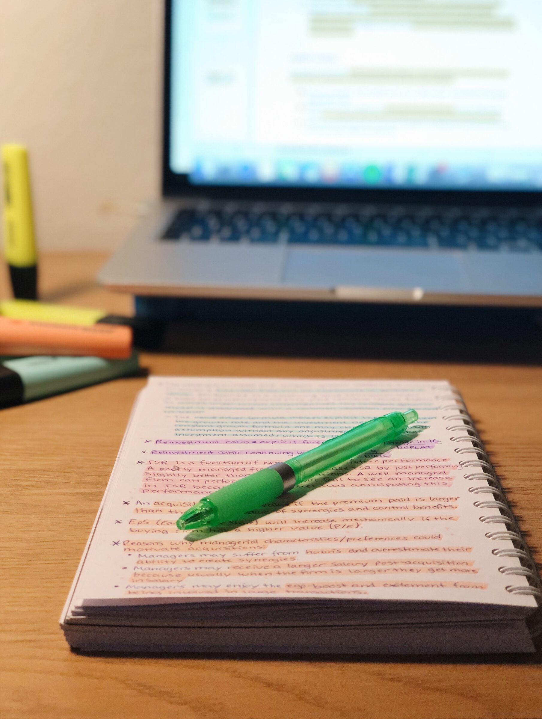 Photo of a pen lying on a notebook  with text